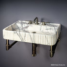 Fluted Lumbre Bath Sink carved from Viola Bianco Marble on an Elemental Facet Wall Unit in graphite