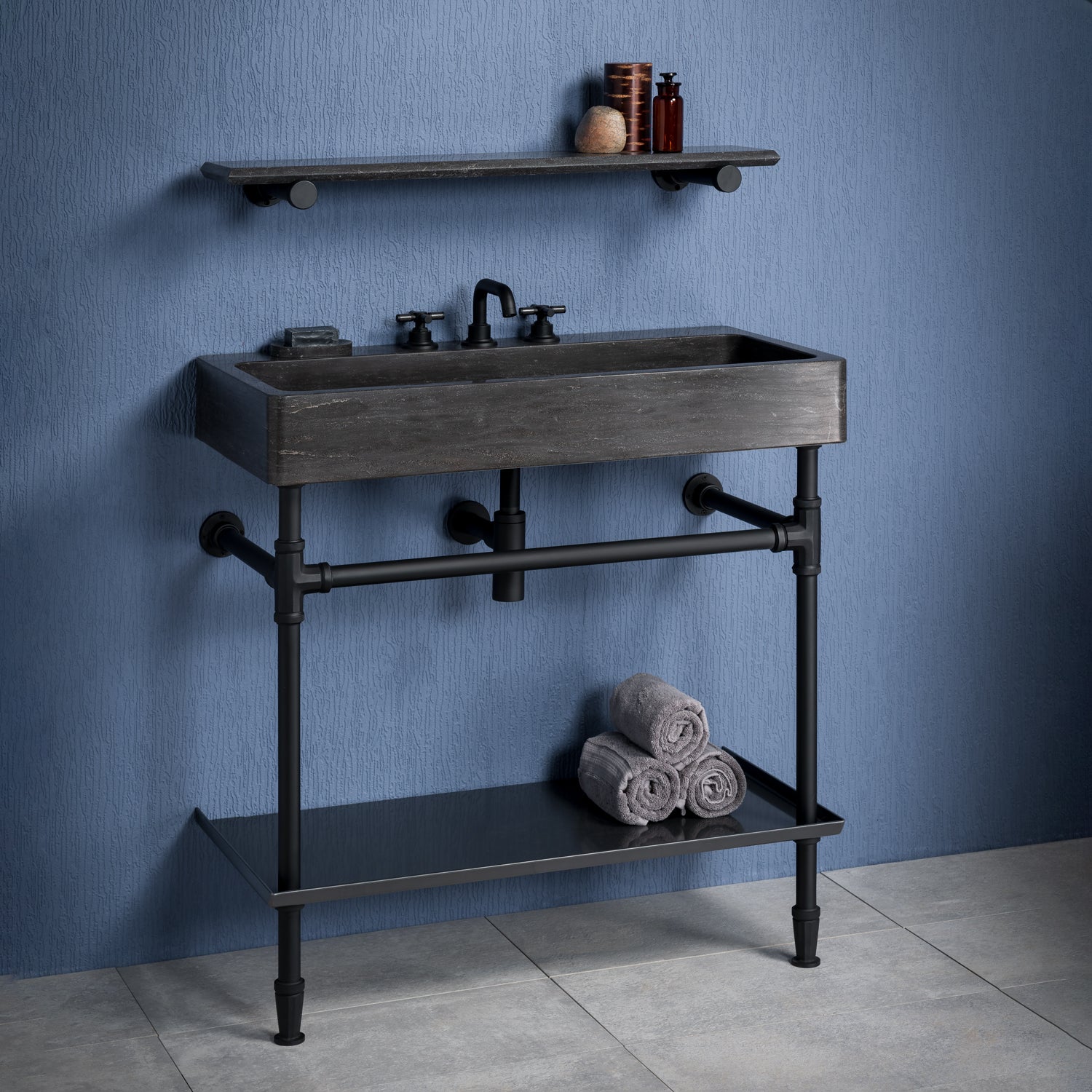 Antique gray limestone Trough console bath sink with matte black Elemental Facet vanity and crossbar with metal tray, and accessory shelf