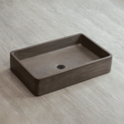 Rectangular concrete sink on a light gray background