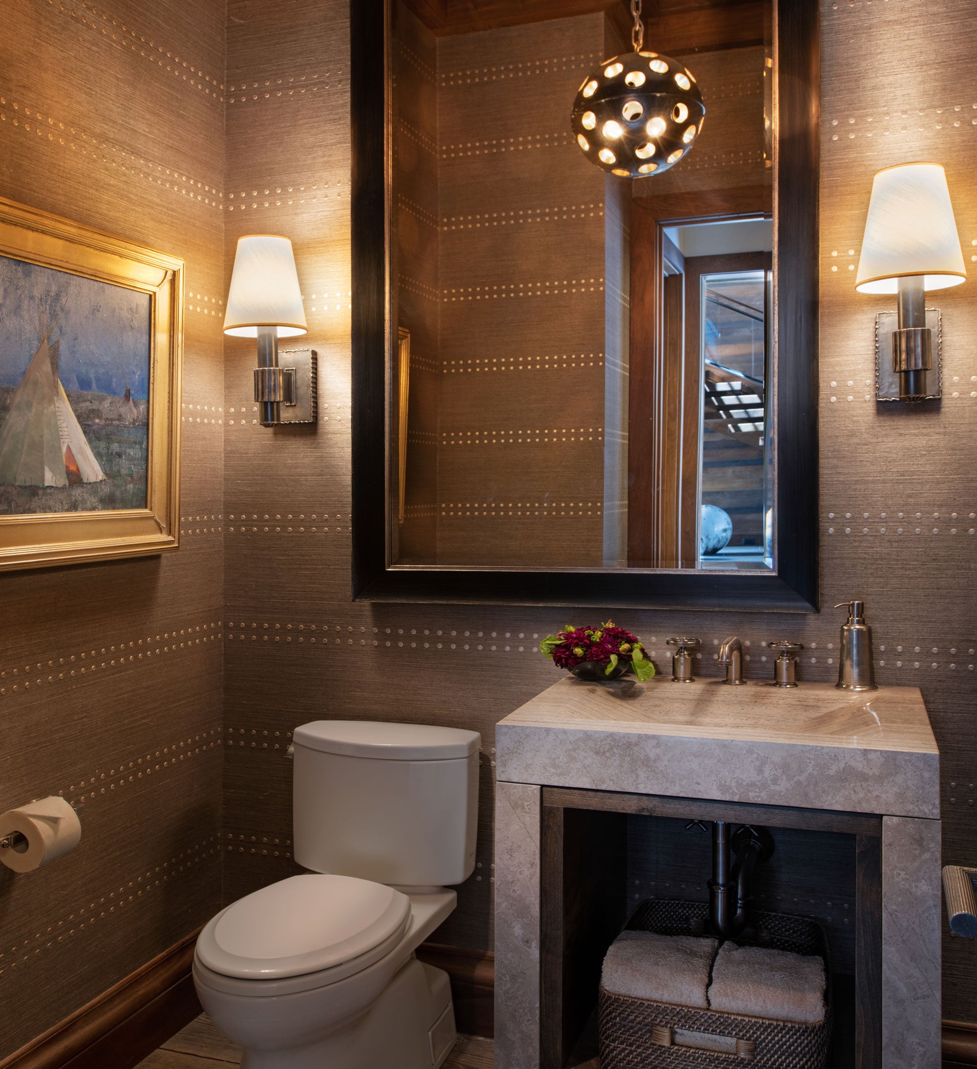 Bathroom with toilet, sink, and decorative elements