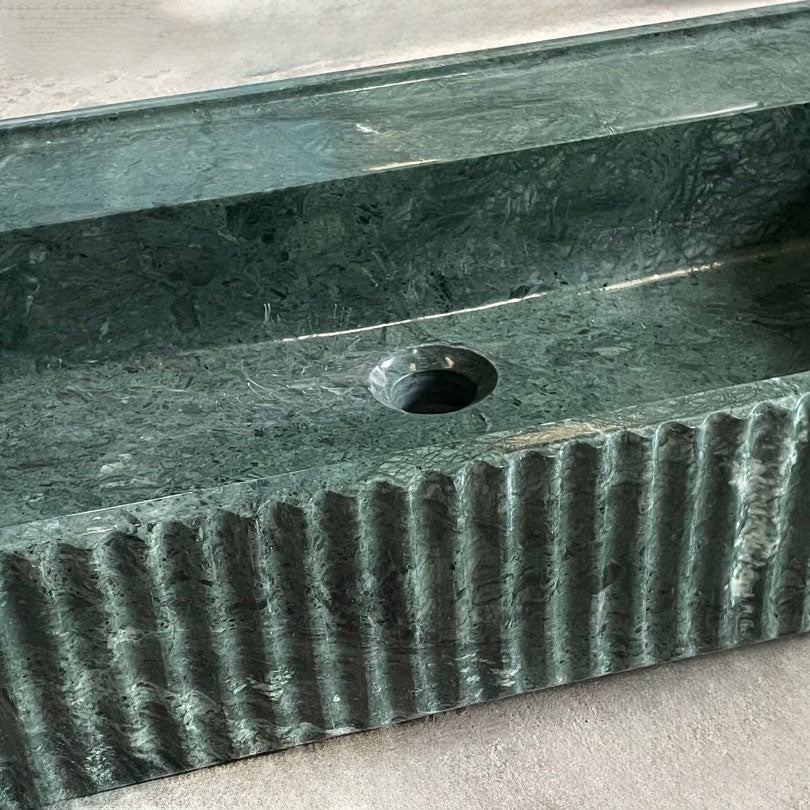 Fluted Lumbre bath sink in verde indio marble close up