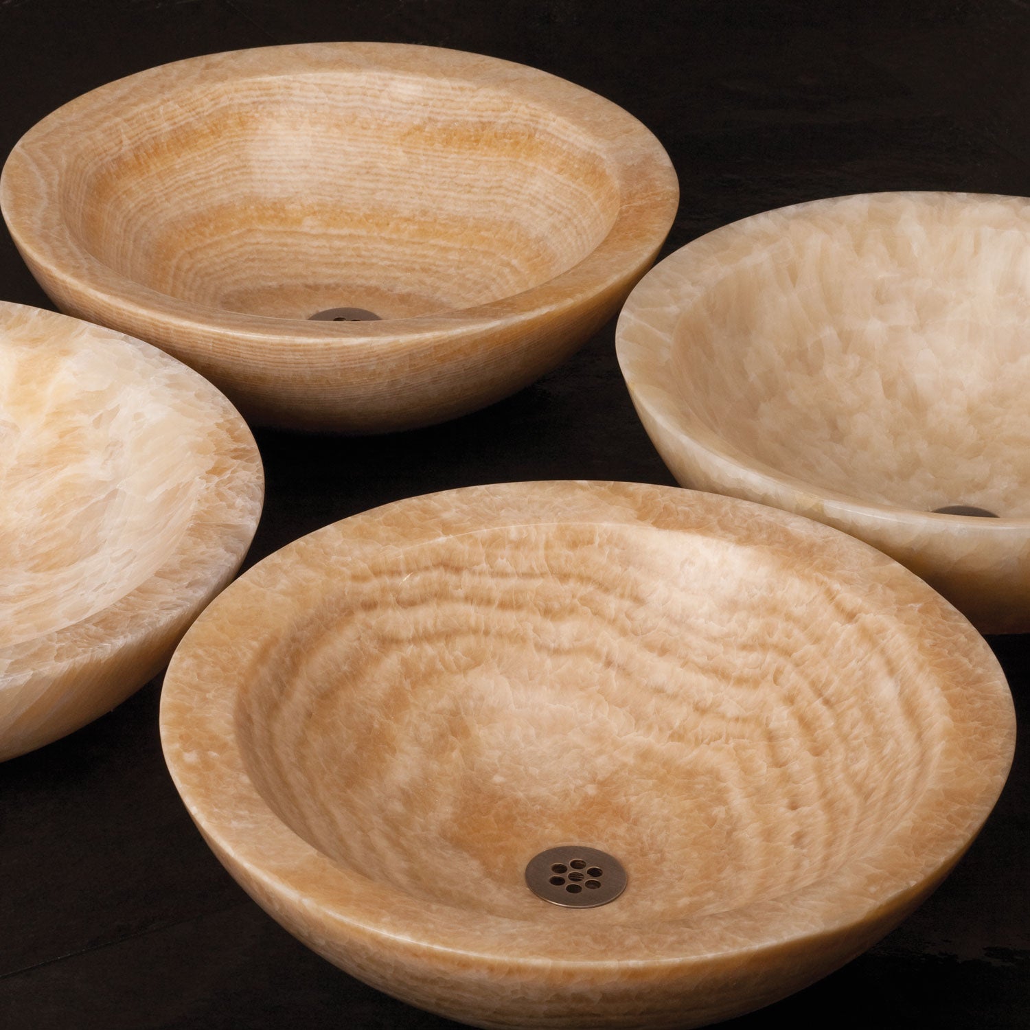 Beveled round vessels in honey onyx, showing variation