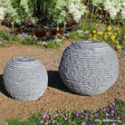 Stone Forest Ribbed Sphere garden fountain carved from black and white granite 18" & 24" high