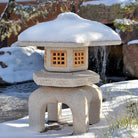 Stone Forest Antique Yukimi: hand-carved, traditional Japanese lantern made of beige granite., with snow on the roof