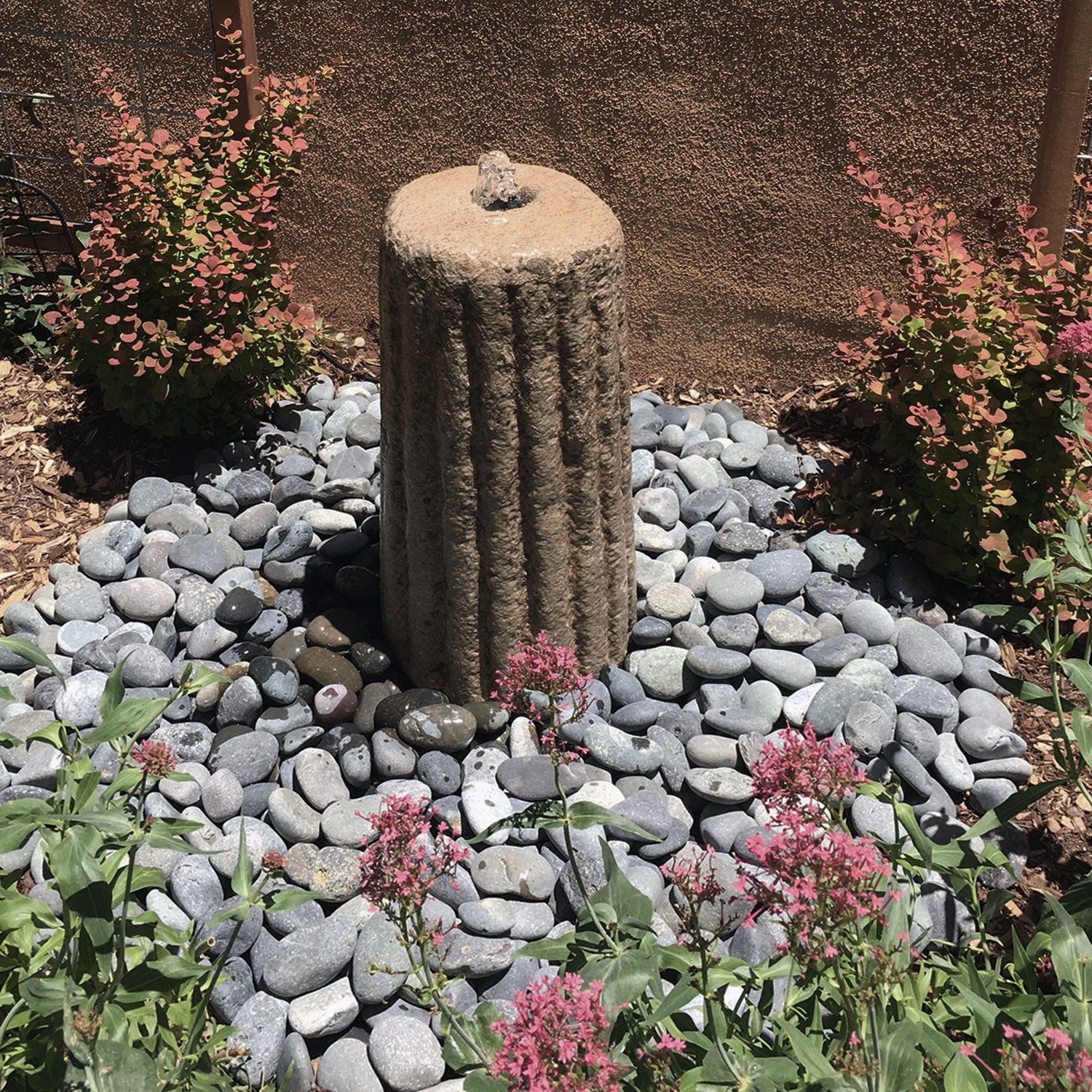 Stone Forest Small Antique Grinding Stone carved from beige granite used as garden fountain