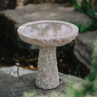 birdbath is hand-carved from Rose Granite with a rough chiseled finish