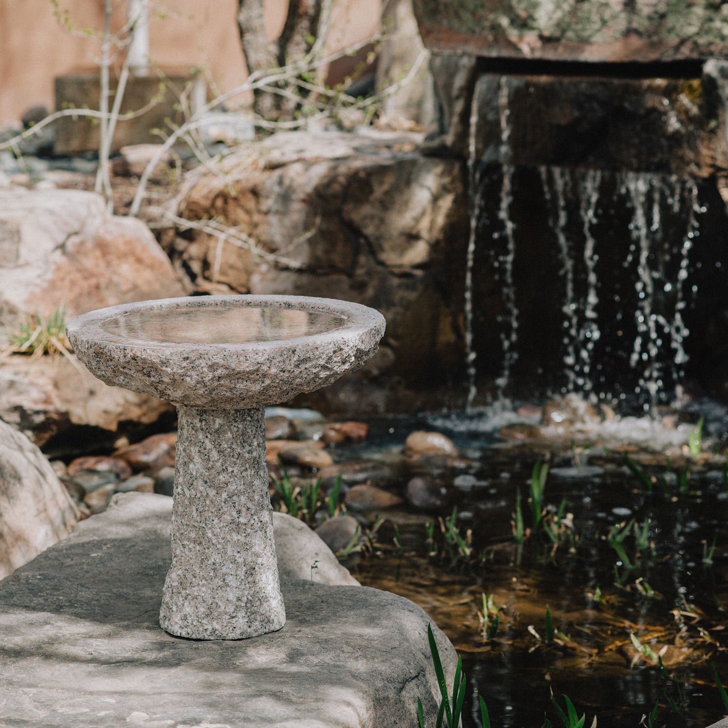 birdbath is hand-carved from Rose Granite with a rough chiseled finish