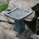 This birdbath is hand-carved from blue-gray granite with a rough chiseled finish