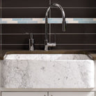 The back side of a carrara marble New Haven Farmhouse Sink has a smooth polished finish that can face forward. 