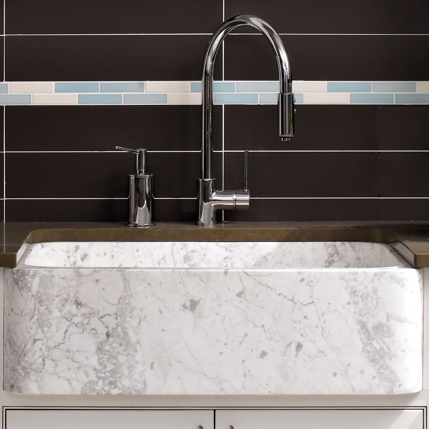 The back side of a carrara marble New Haven Farmhouse Sink has a smooth polished finish that can face forward. 