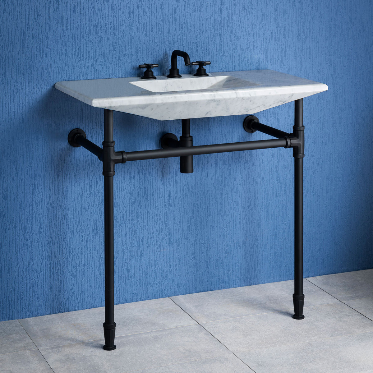 Stone Forest Cortina Console Sink carved from a single block of carrara marble paired with matte black Elemental Facet Legs with Crossbar. image 1 of 3