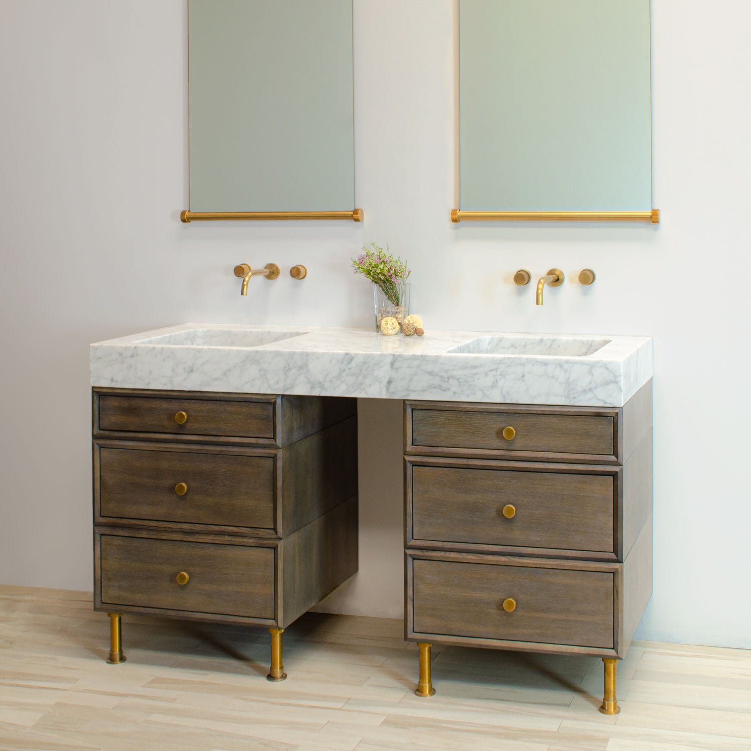 Custom Double Terra Bath Sink in honed carrara marble paired with Custom Elemental Classic Vanity in aged brass with two drawer stacks.