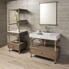A Carrara marble bath sink on an Elemental Classic Drawer Vanity with an aged brass finish and wood elements. With a storage unit on the left.