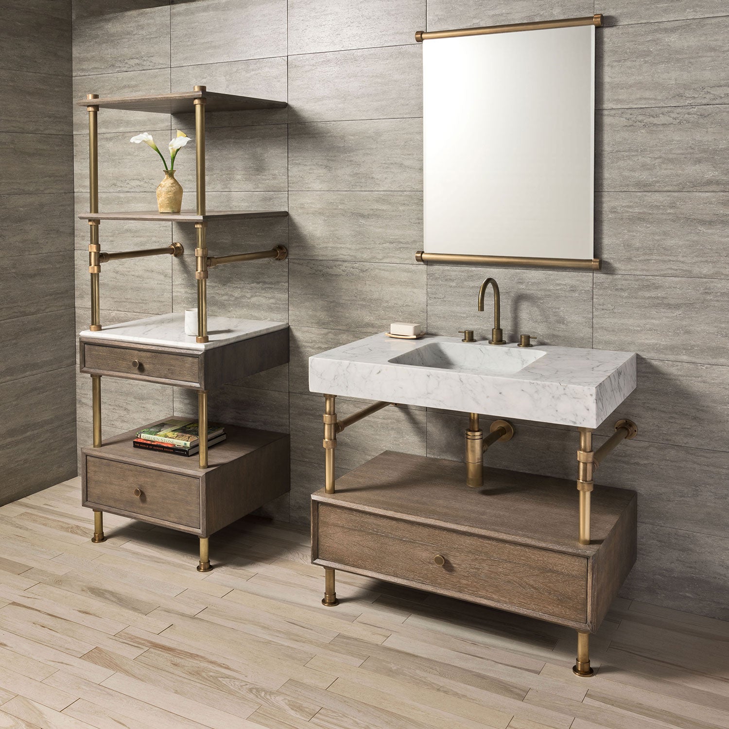A Carrara marble bath sink on an Elemental Classic Drawer Vanity with an aged brass finish and wood elements. With a storage unit on the left.