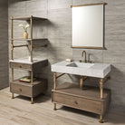 A Terra Bath Sink made of Carrara Marble, placed on an Elemental Drawer Vanity in aged brass, with additional storage options in the form of shelves and drawers, set against a tile wall in a modern bathroom setting.