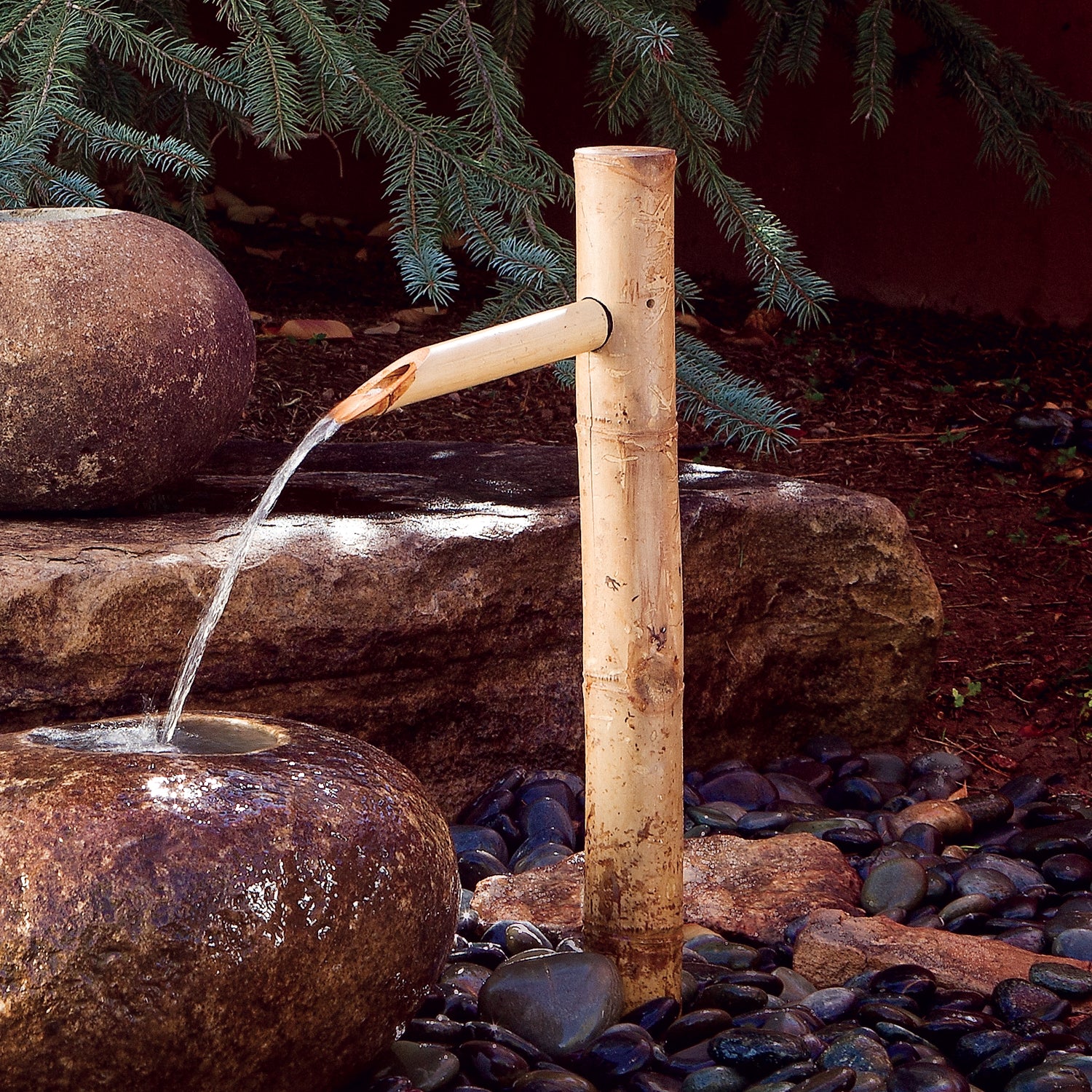 Bamboo water spout for use with basin-style fountains.
