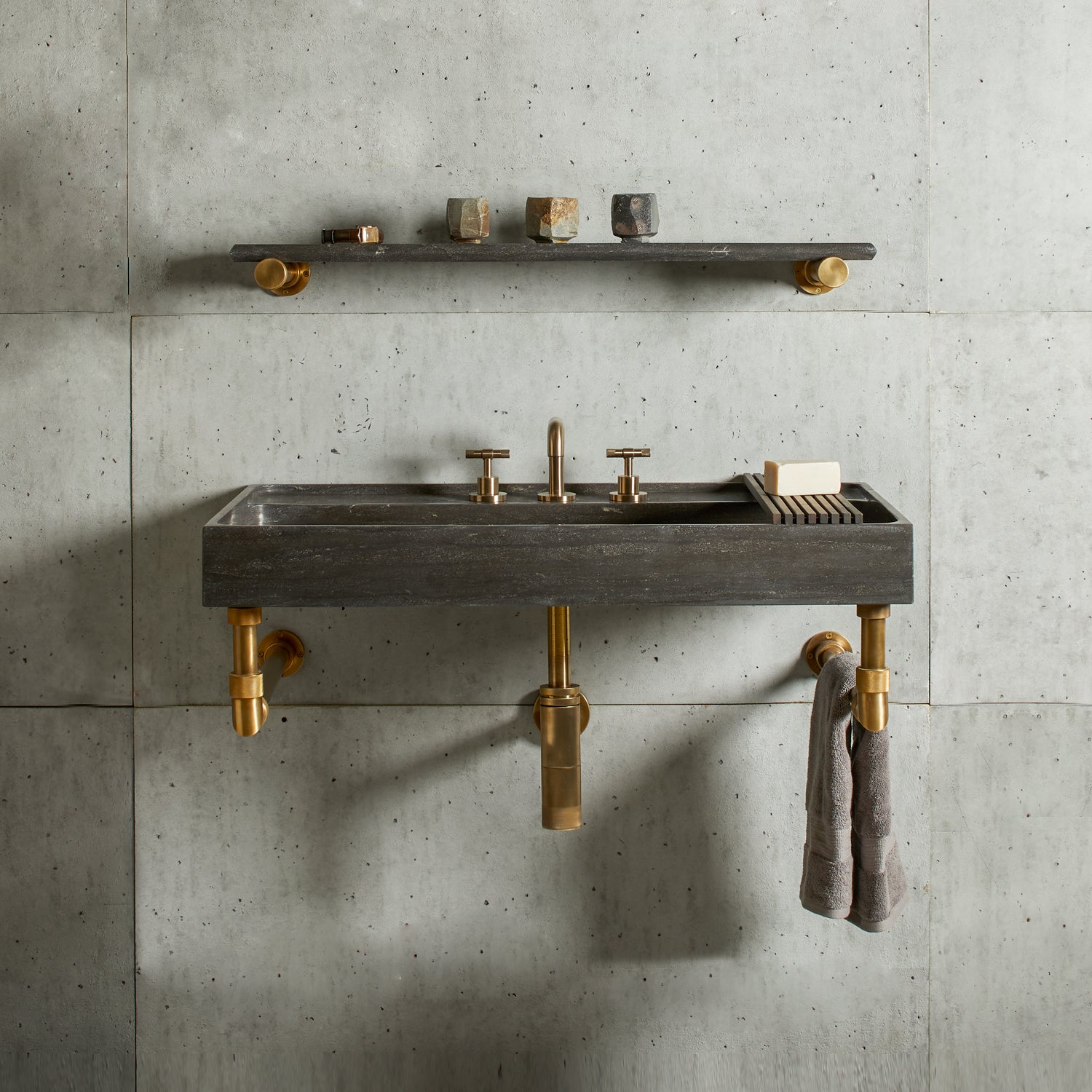 Ventus Bath Sink with Faucet Deck in antique gray limestone Paired With Elemental Classic Wall Unit in aged brass