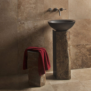 Stone Forest Basalt Pedestal cut from a solid column of natural basalt.  Each piece features polished sides with contrasting natural textures paired with a black granite beveled Vessel sink. image 3 of 3
