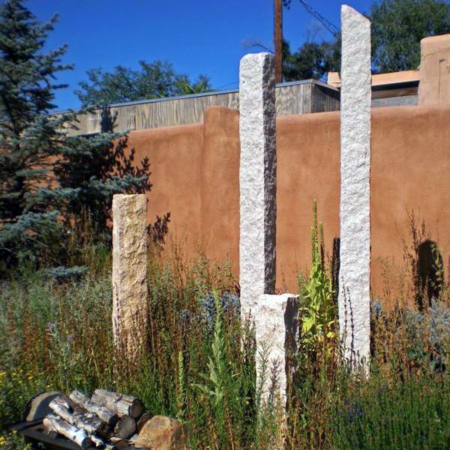 Garden Ornament: Rough chiseled plinths carved from beige granite used as sculptural accents