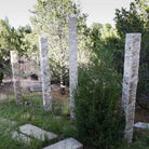 Garden Ornament: Rough chiseled plinths carved from beige granite used as sculptural accents