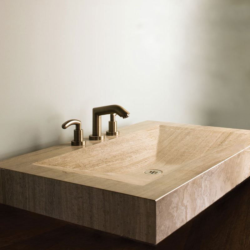 A rectangular modern stone sink with a recessed design in siena silver gray marble