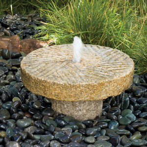 Outdoor fountain: small antique millstone fountain