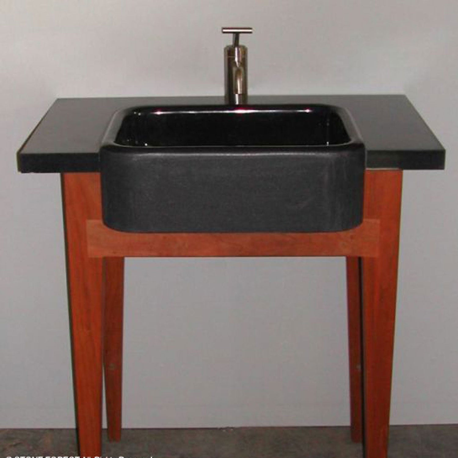 A black granite washbasin, all polished.