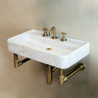 Carrara Marble Lembre bath sink on Elemental Classic wall unit in aged brass