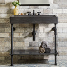 Antique gray limestone trough sink paired with a matte black elemental classic trough tray vanity.