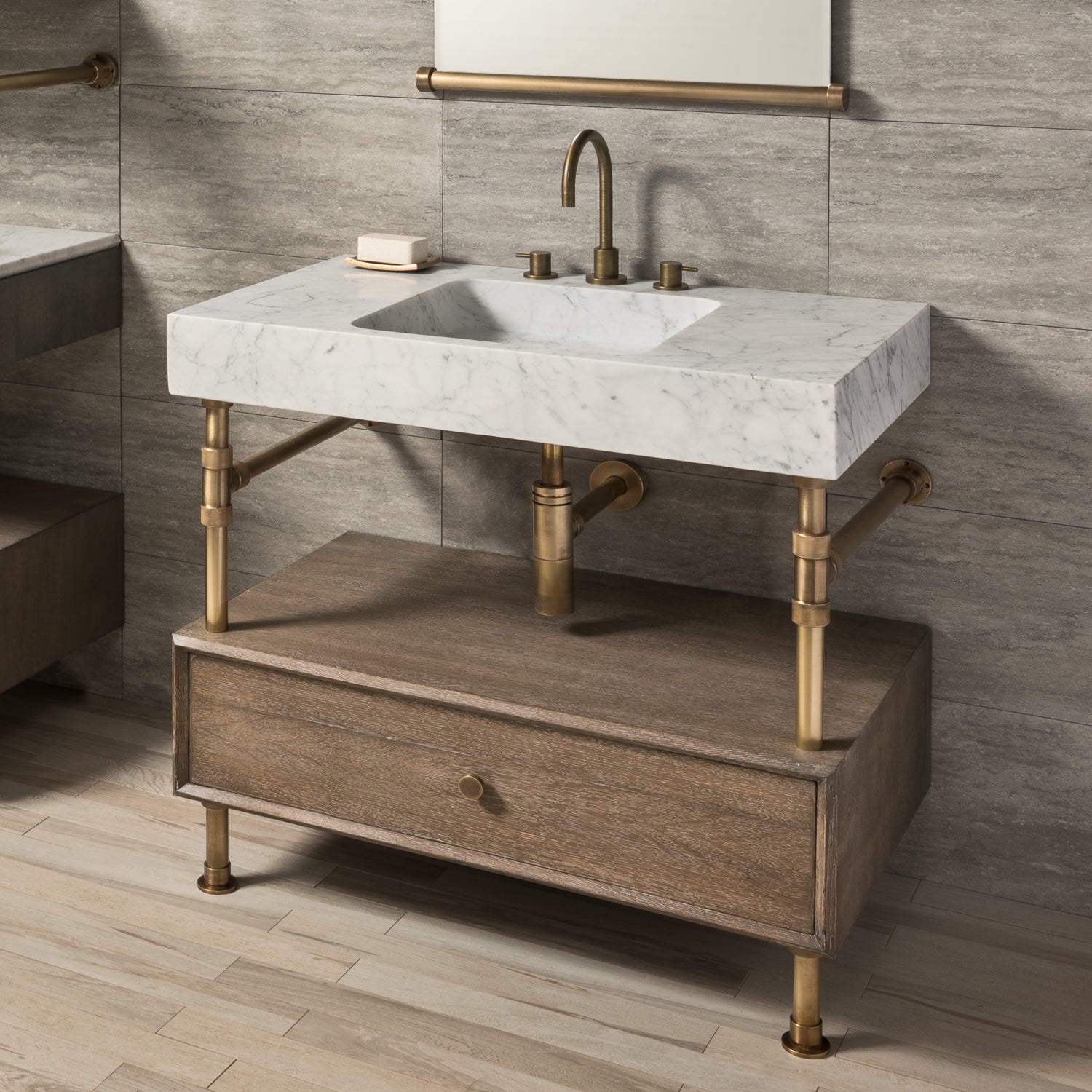 A Carrara marble bath sink on an Elemental Classic Drawer Vanity with an aged brass finish and wood elements.