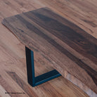 Closup picture of large hardwood bench with metal legs